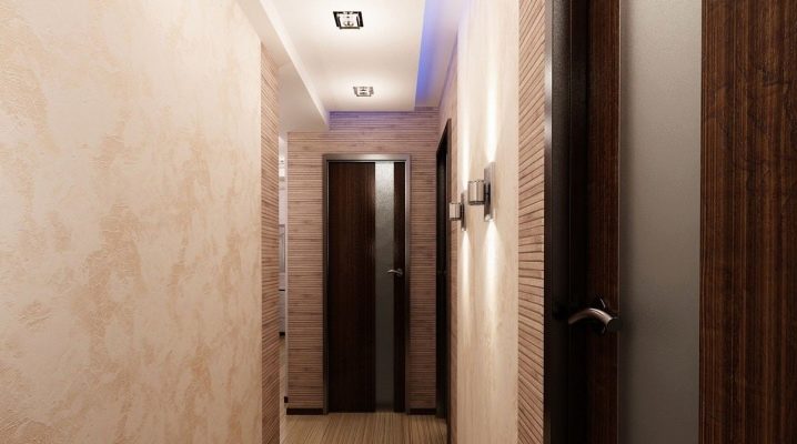 Choosing wallpaper in the corridor under dark doors